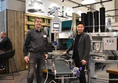 Hans Lütmann of Klarmann and Lun Li of Mayer in front of The new potting machine TM 24 32 D which van switch between double and single pots. Klarmann is The Mayer distributed in north Germany.